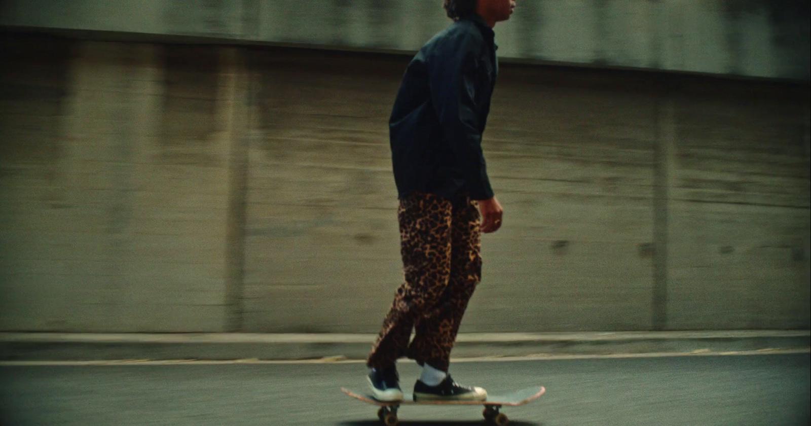 a man riding a skateboard down a street