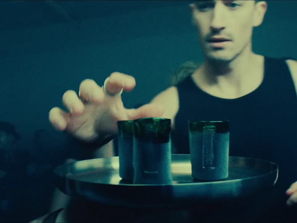 a man holding two cups in his hands