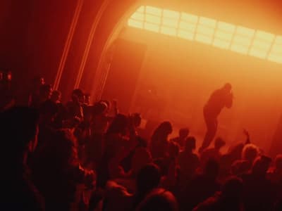 a crowd of people standing around a stage