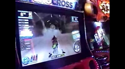 a person playing a video game on a large screen