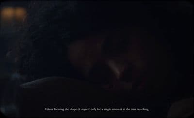 a woman is sleeping in the dark with her eyes closed