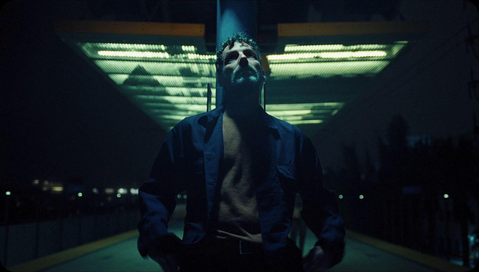 a man standing in front of a building at night