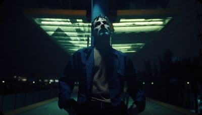 a man standing in front of a building at night