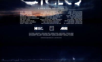 a movie poster with a dark sky and clouds in the background
