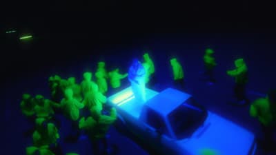 a group of people standing around a car in the dark