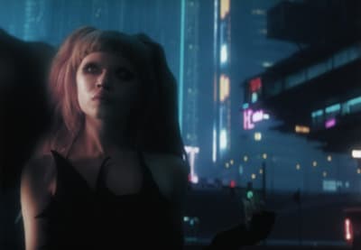 a woman standing in a city at night