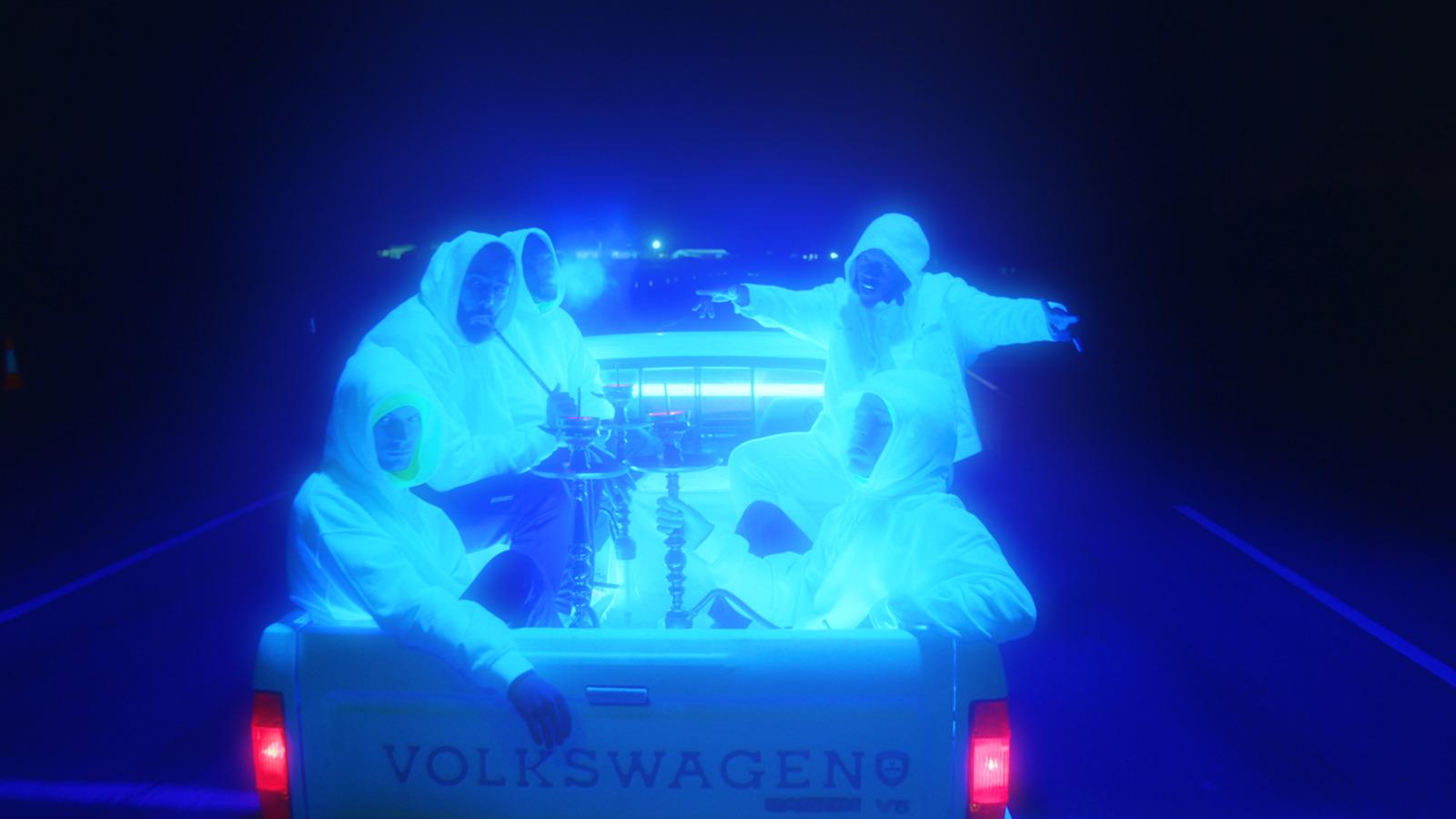 a couple of people in ghost costumes riding in the back of a truck