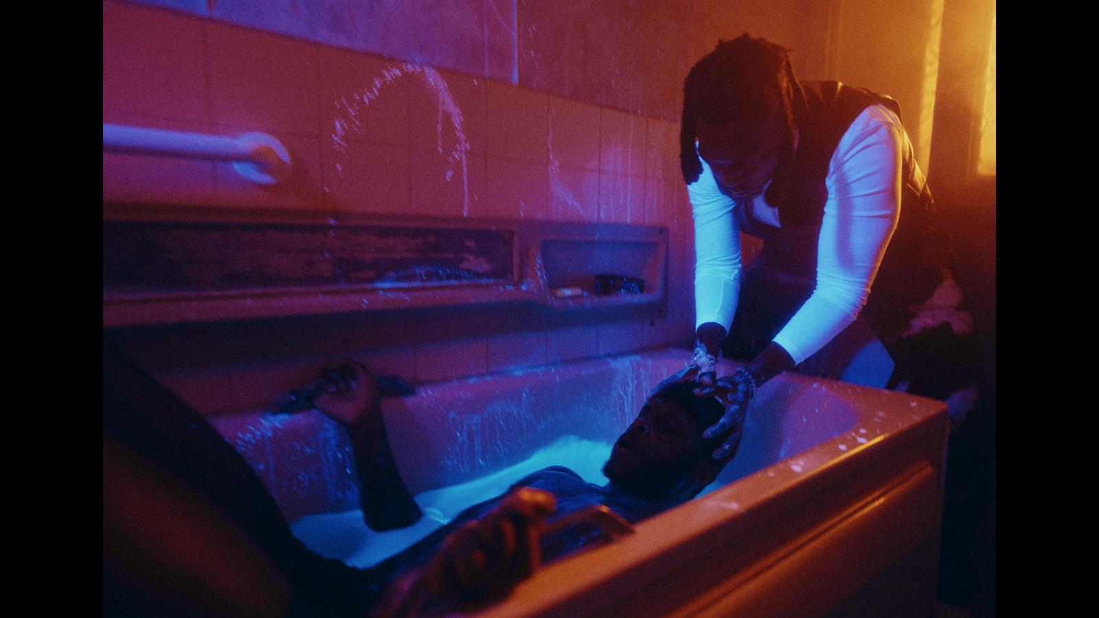 a man in a bathtub with a woman in the tub