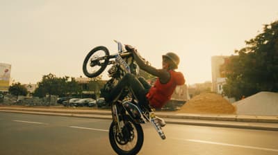a person doing a trick on a motorcycle