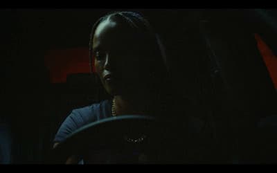 a woman driving a car in the dark