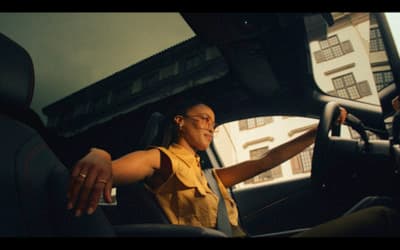 a woman sitting in the driver's seat of a car