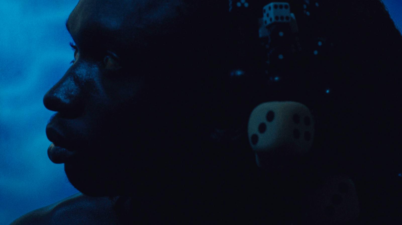 a man with a pair of dice in his hair