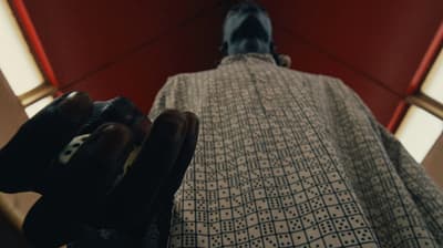 a person standing in front of a mirror wearing gloves