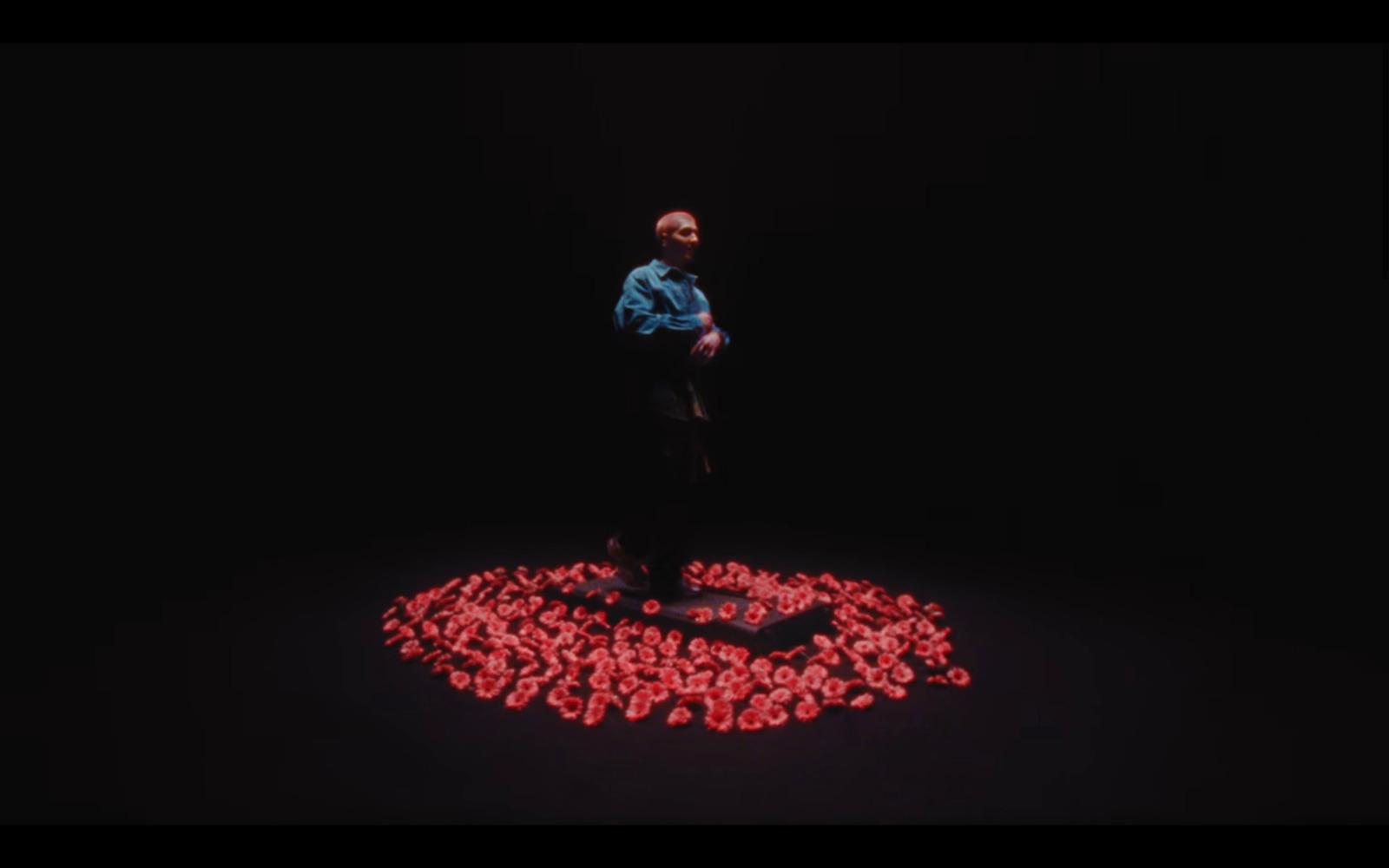 a man standing in the middle of a circle of hearts