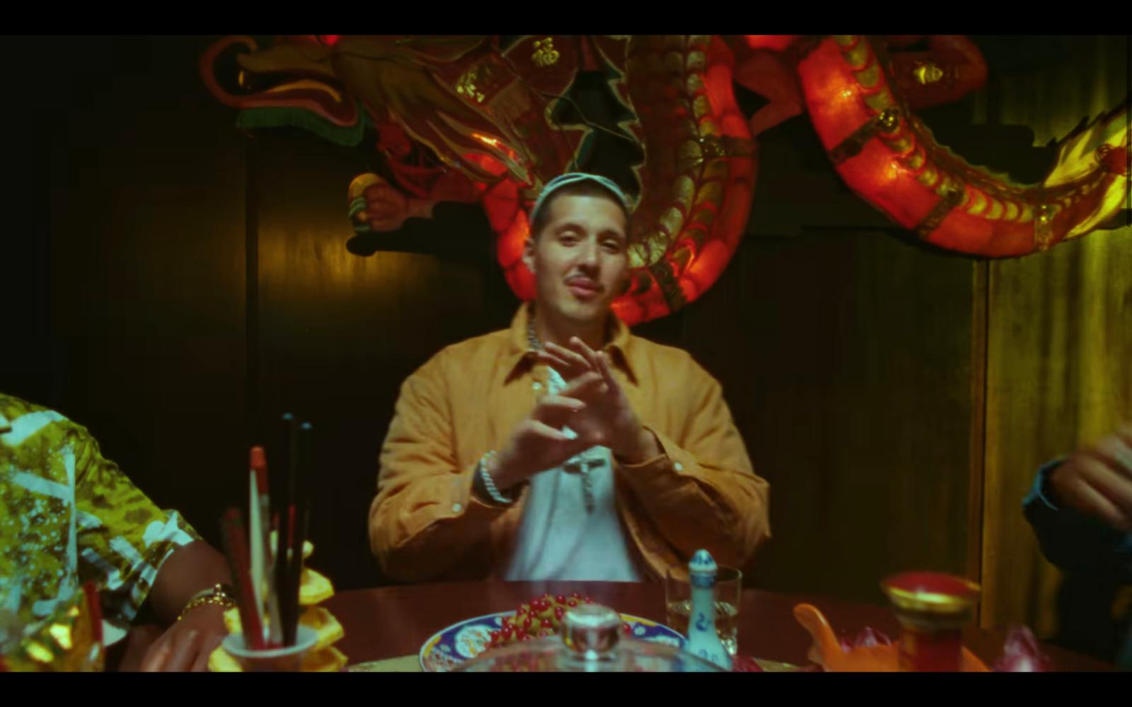a man sitting at a table in front of a dragon