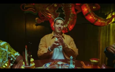 a man sitting at a table in front of a dragon