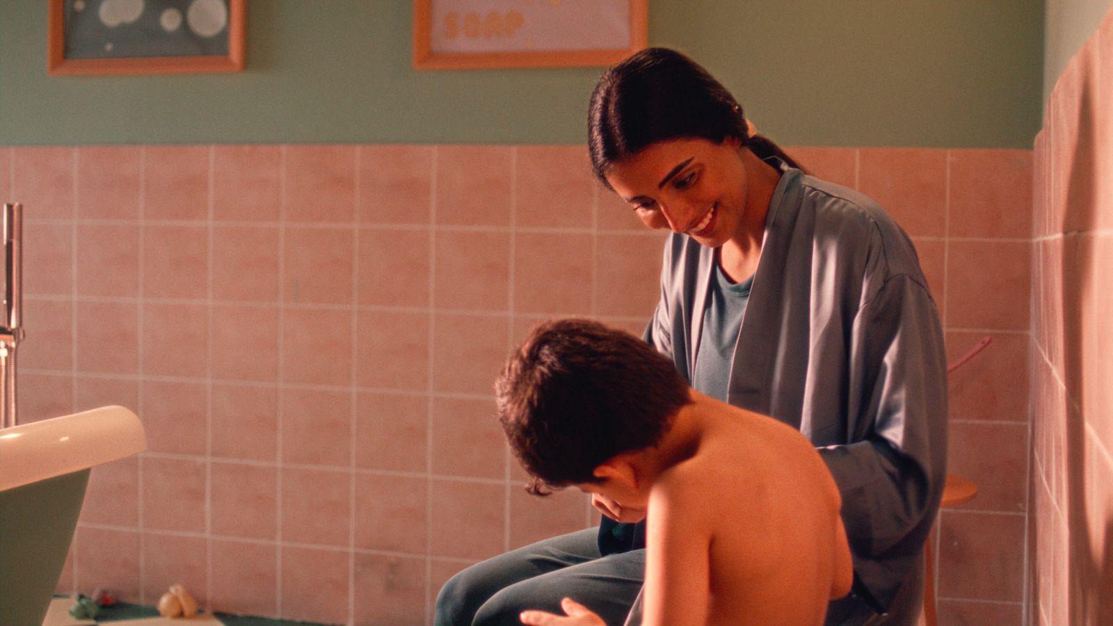 a woman and a young boy in a bathroom