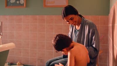 a woman and a young boy in a bathroom