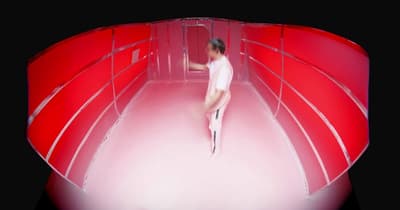 a woman is walking through a red room