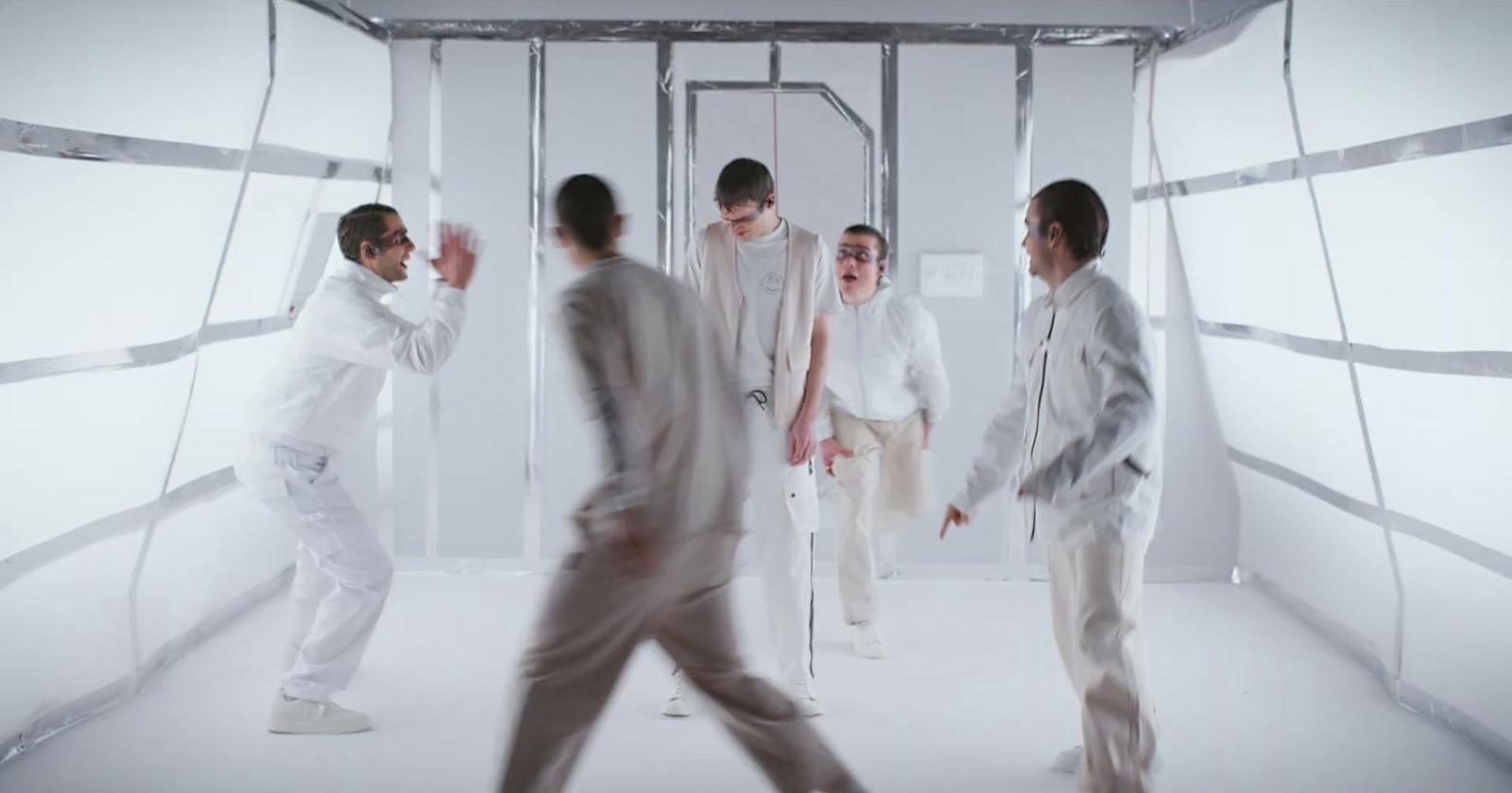 a group of men standing around each other in a room