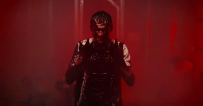 a man standing in a dark room with red light