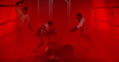 a group of people standing in a red room