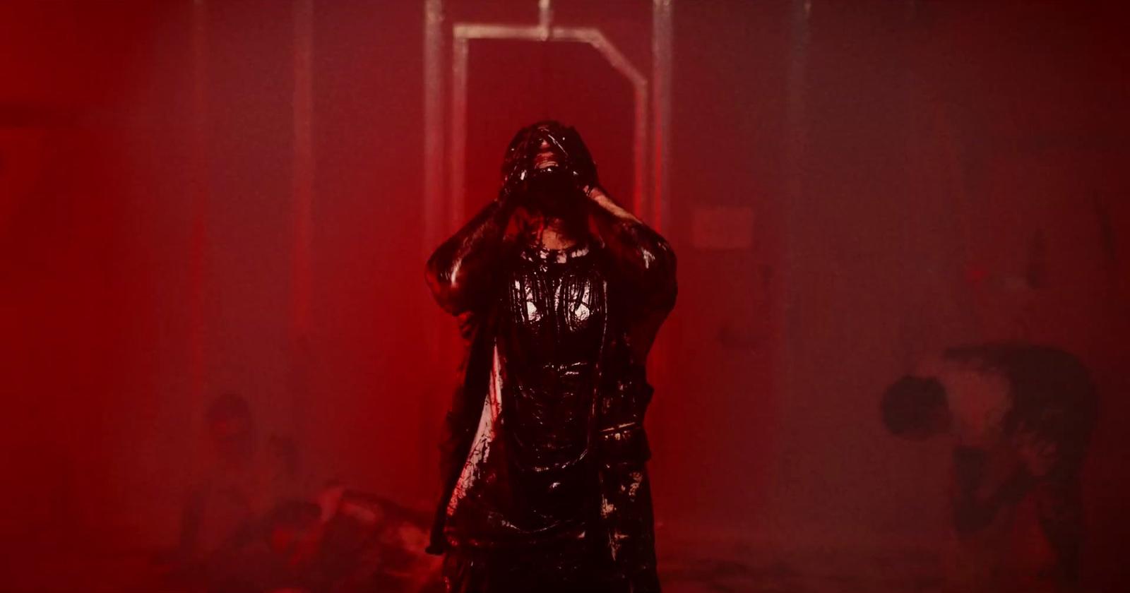 a person in a dark room with a red light
