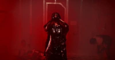 a person in a dark room with a red light