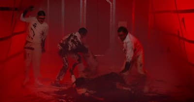 a group of men standing next to each other in a room