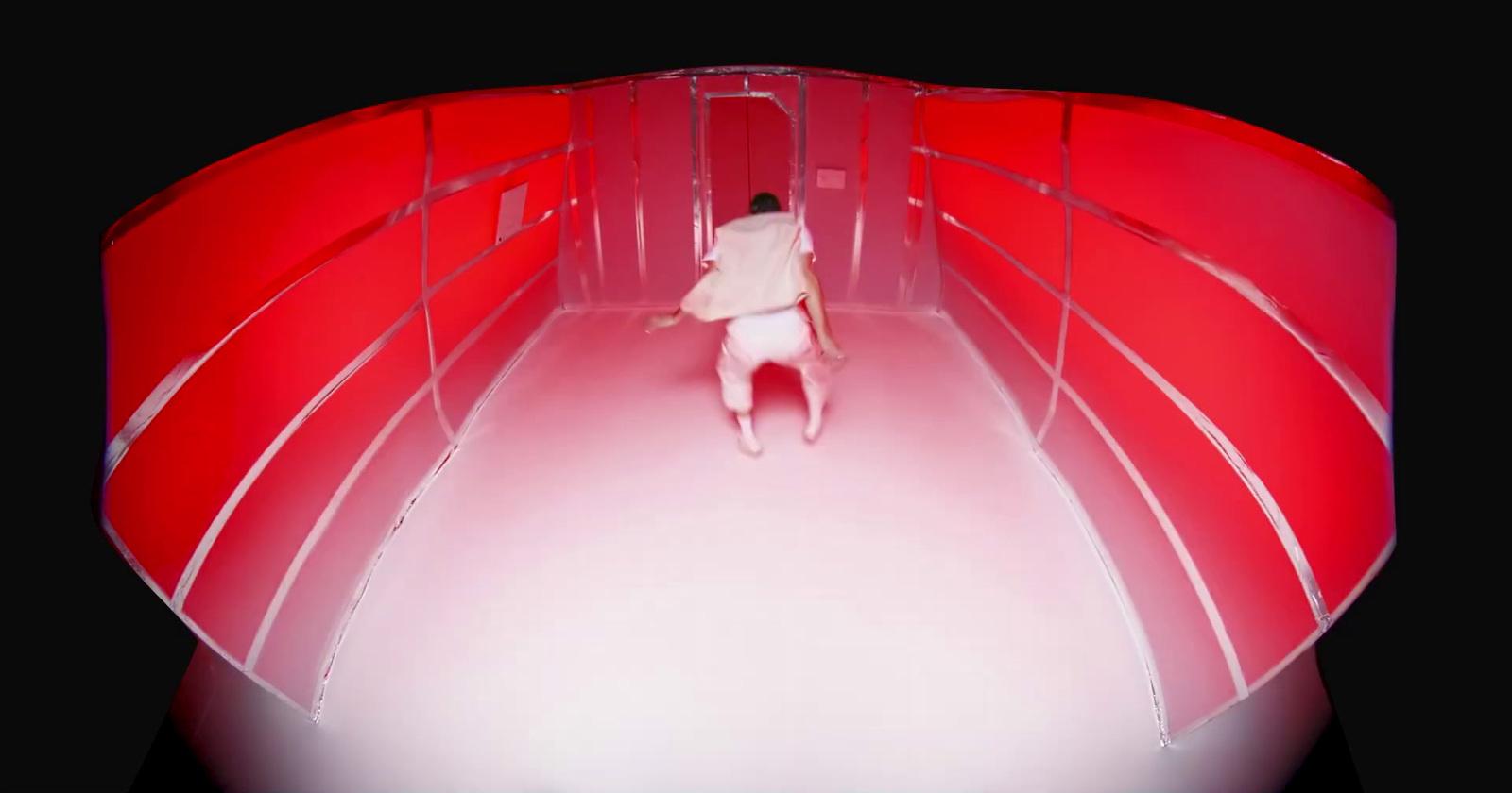 a person standing in a room with red walls