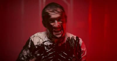 a man with his face covered in plastic wrap