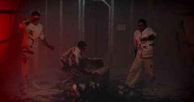 a group of men standing next to each other in a room