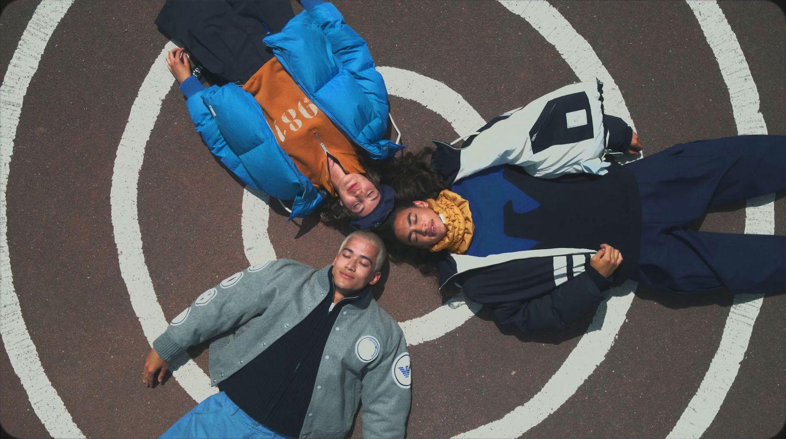 a group of people standing in the middle of a street