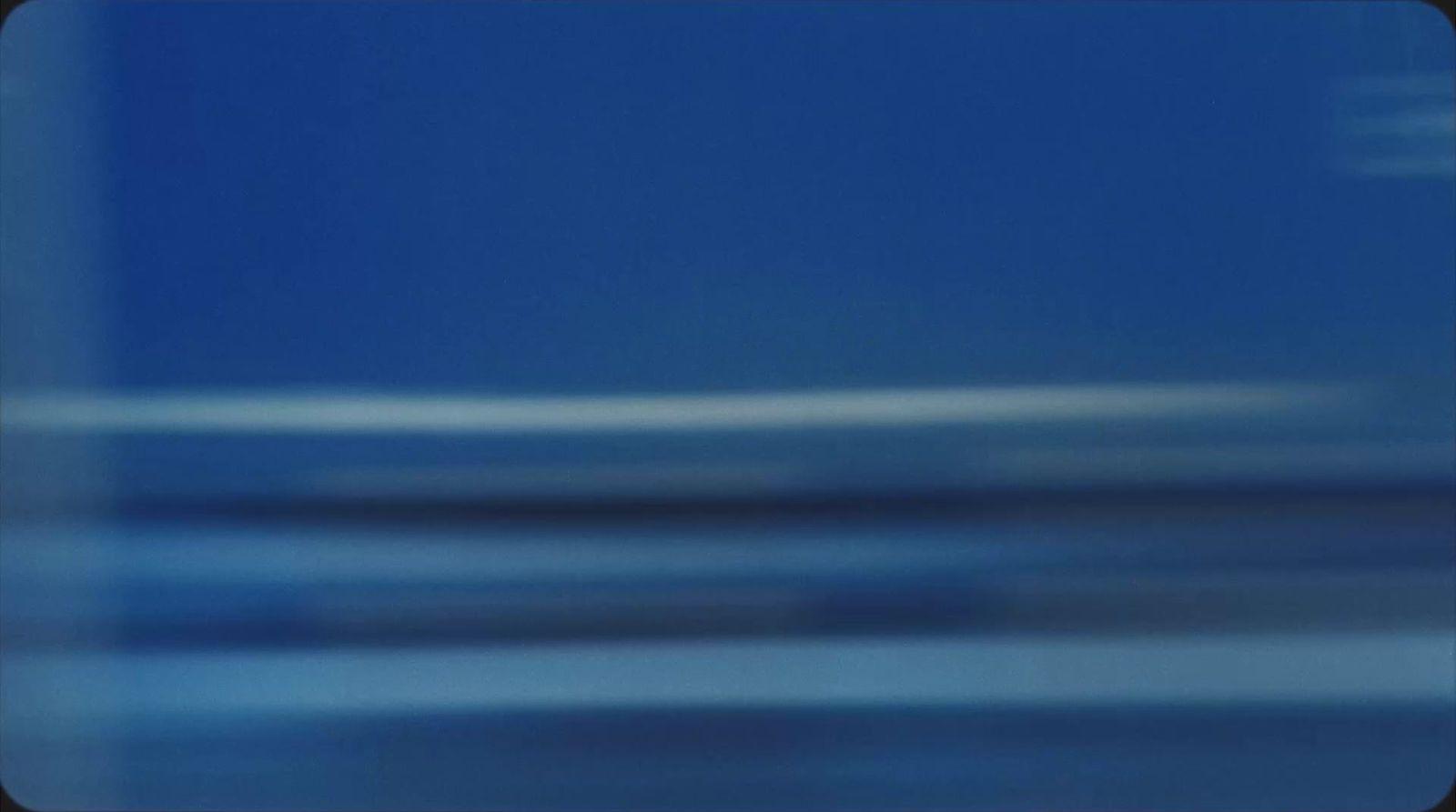 a blurry photo of a blue sky with a plane in the distance