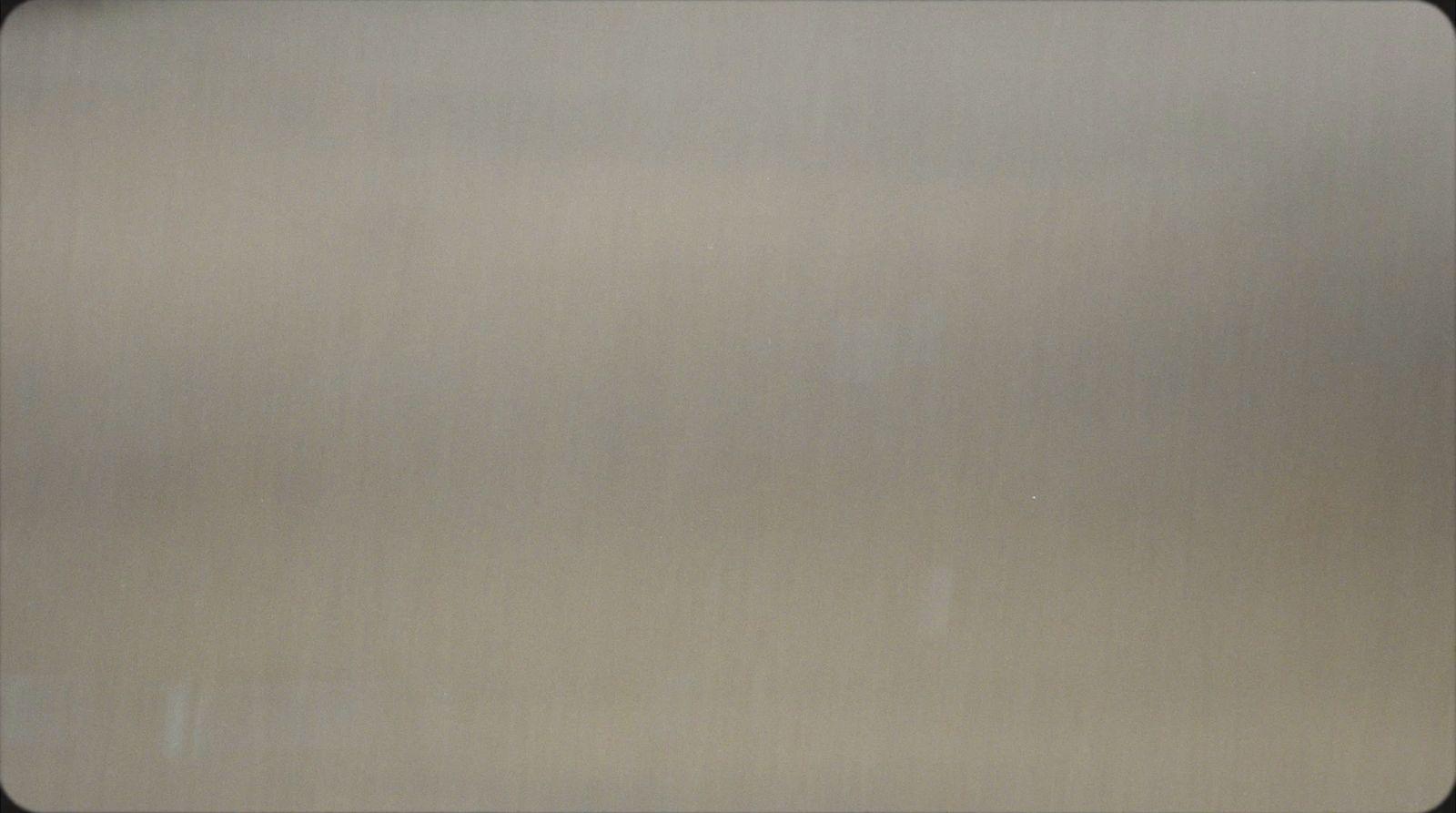 a close up of a metal surface with a black border