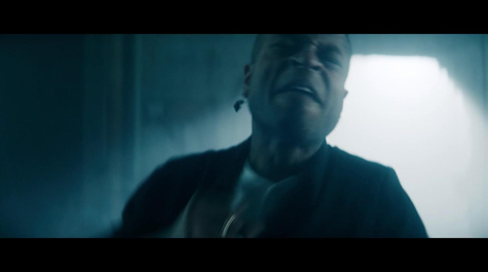 a man in a dark room with his mouth open