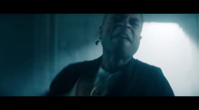a man in a dark room with his mouth open