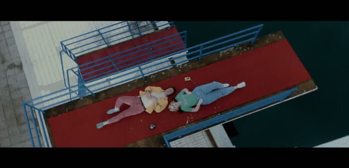 a couple of people laying on top of a red floor