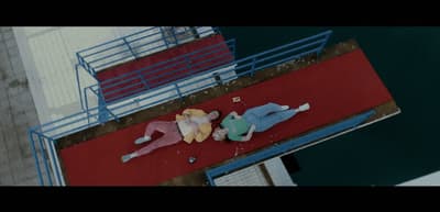 a couple of people laying on top of a red floor