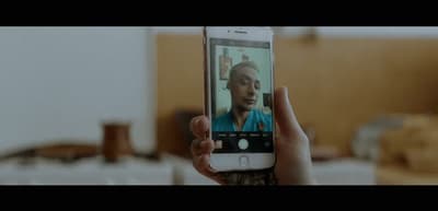 a person holding up a cell phone to take a picture