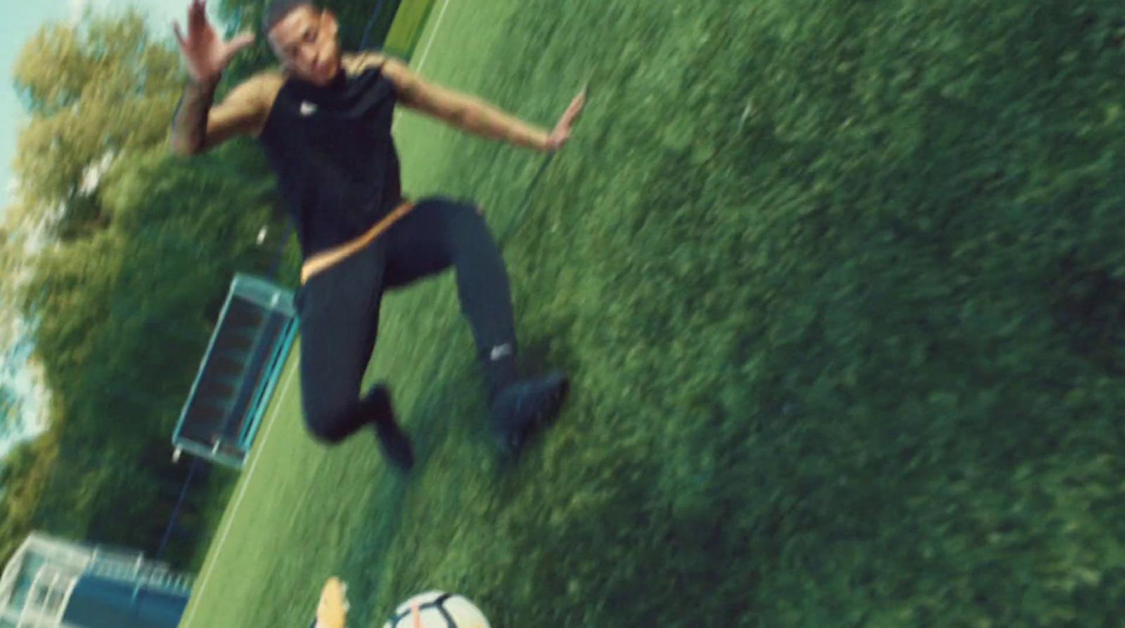 a man is kicking a soccer ball on a field