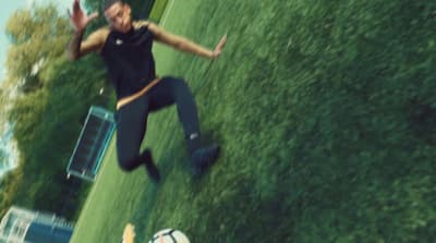 a man is kicking a soccer ball on a field
