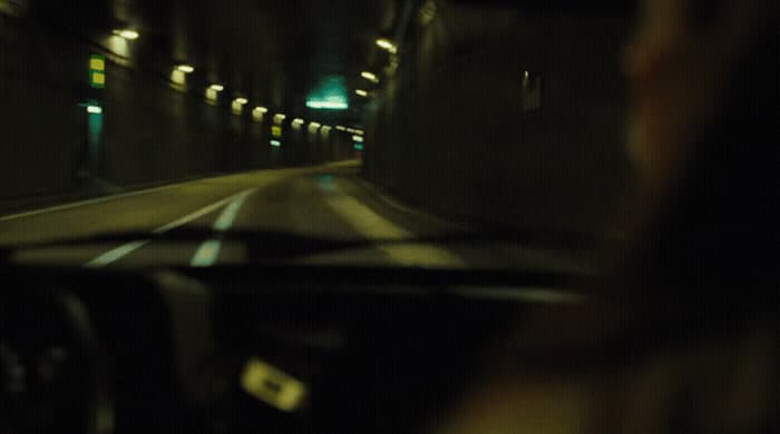 a woman driving a car through a tunnel