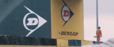 a man standing on top of a building next to a sign