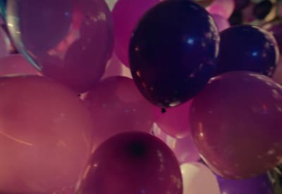 a bunch of balloons that are purple and pink