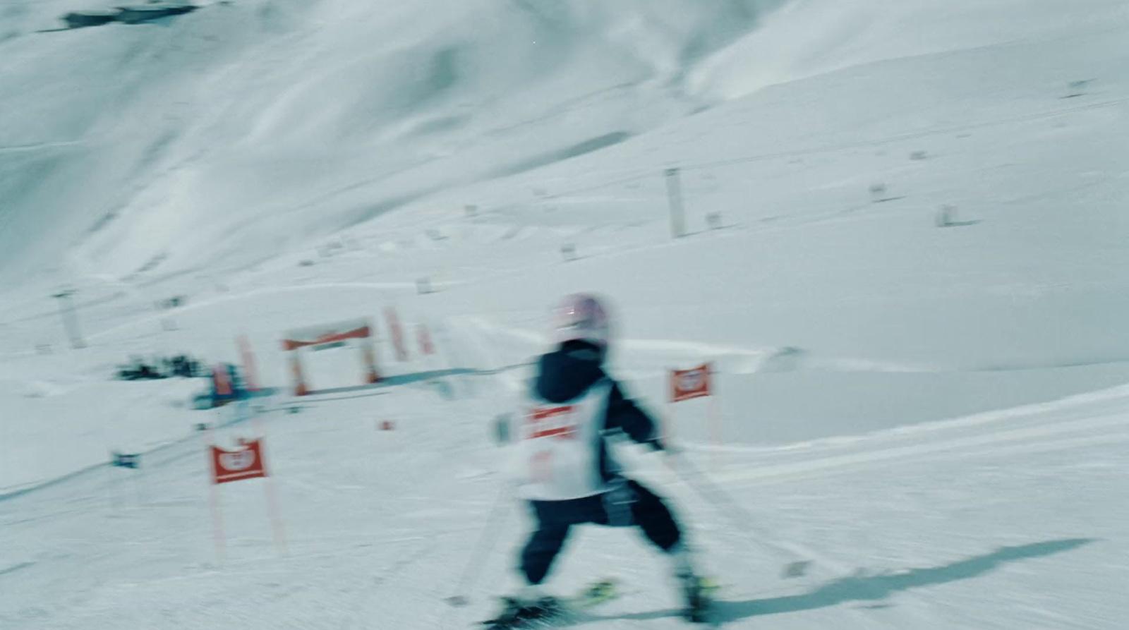 a man riding skis down a snow covered slope