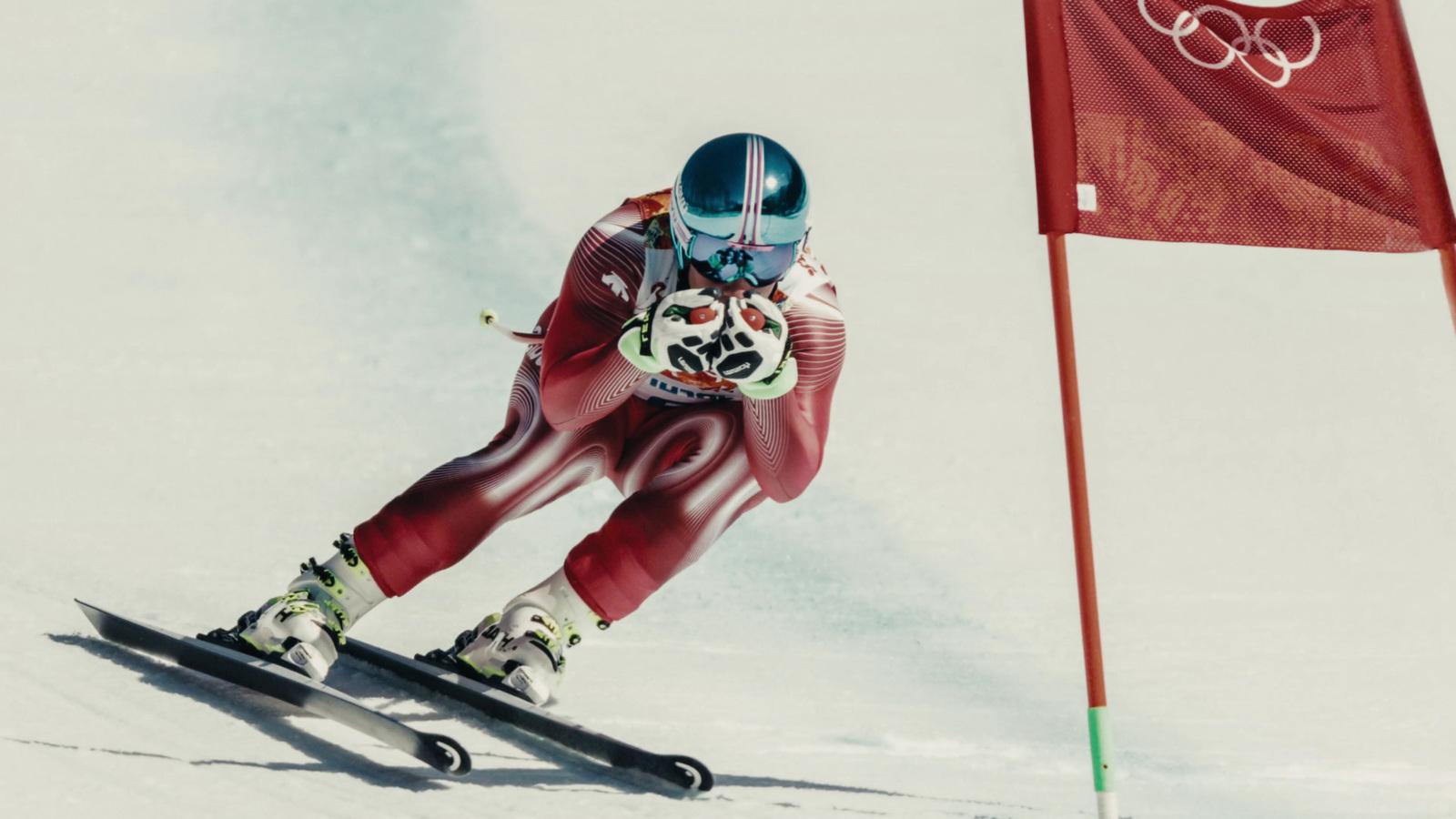 a man riding skis down a snow covered slope