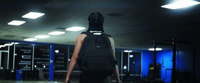 a person with a back pack walking through an airport