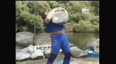 a man in a blue shirt is doing a trick