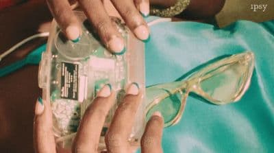 a woman in a blue dress holding a cell phone